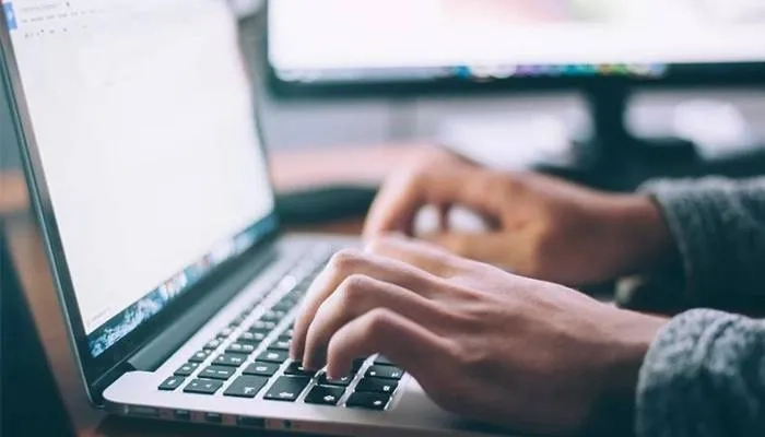 Person typing on laptop